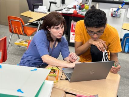 Two students looking at the computer